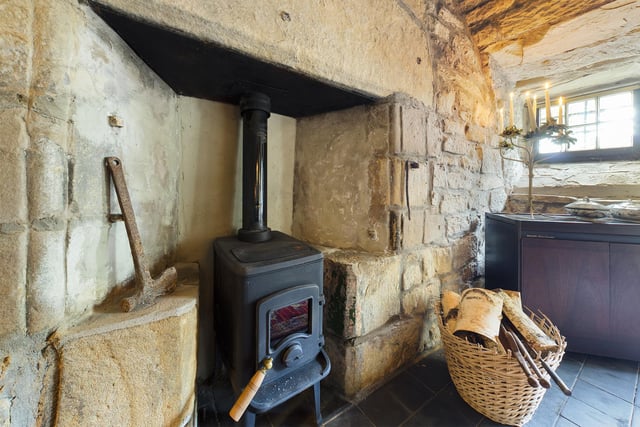 The fireplace harks back to a bygone era and is one of the many charming features you'll find in this property.