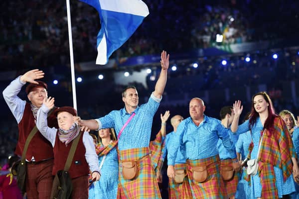 Scottish athletes are led out by judoka Euan Burton at the opening ceremony of the 2014 Commonwealth Games at Celtic Park. (Photo: Craig Williamson/SNS)