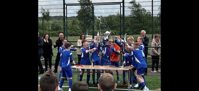 Knowetop Primary School players celebrate their tournament win (Submitted pic)