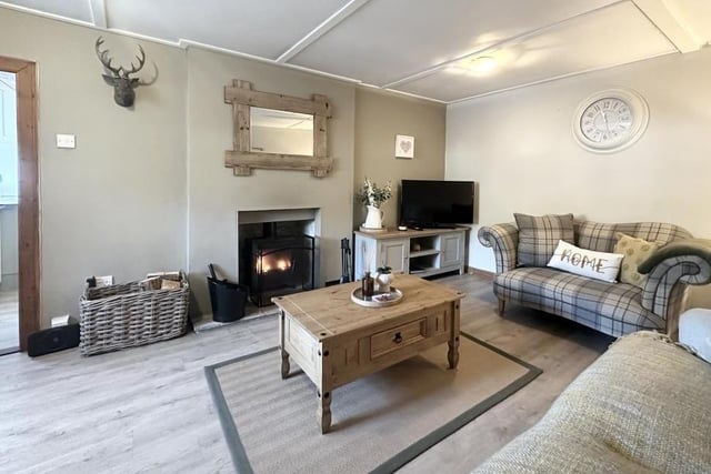 The spacious living room has a feature multi-fuel stove, ideal for curling up on a cold winter's night.