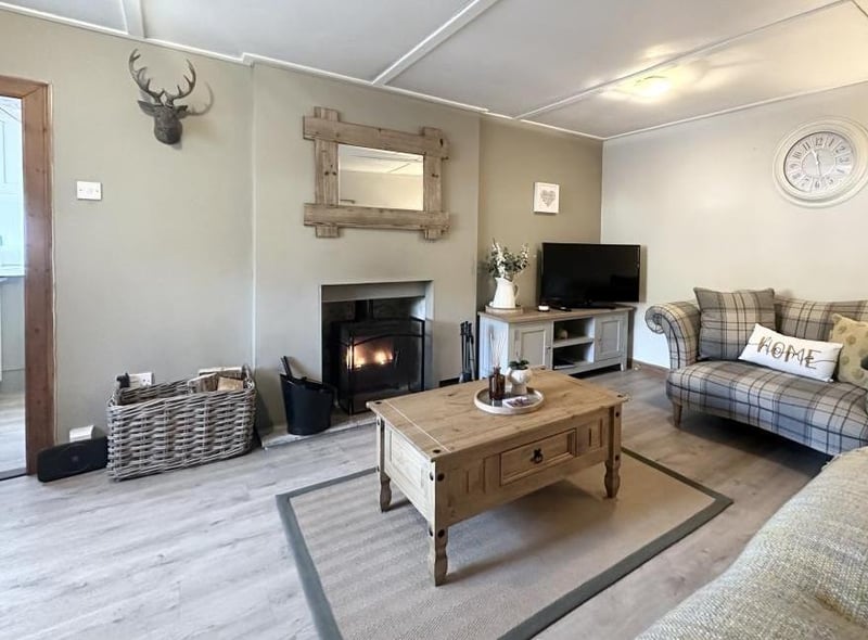 The spacious living room has a feature multi-fuel stove, ideal for curling up on a cold winter's night.