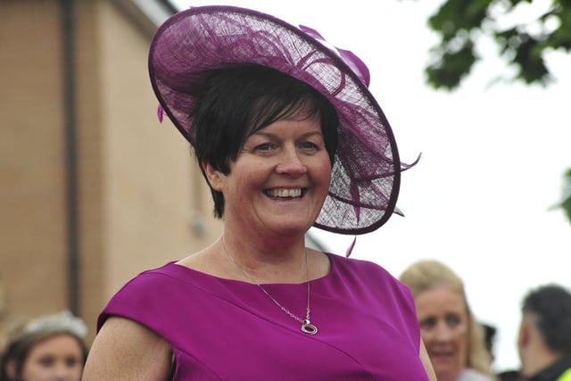Mrs Mairi McMinn looked a vision in a purple dress and fascinator, ready to crown queen-elect Alea Fowler.