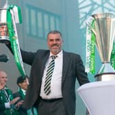 Ange Postecoglou holds aloft the Scottish Cup in front of gathered fans at Celtic Park after completing the domestic treble. (Photo by Ewan Bootman / SNS Gro