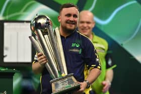Luke Littler poses with the Sid Waddell Trophy after victory over Michael van Gerwen in the PDC World Darts Championship final at Alexandra Palace in London on Friday