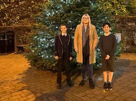 Amy Ted and Alexander pictured in front of the community tree.