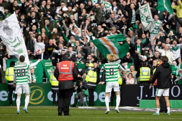 Celtic's Kyogo Furuhashi (centre), Josip Juranovic (left) and Jota celebrate with the Celtic support at full-time of their 7-0 win over St Johnstone on Saturday and manager Ange Postecoglou says the most important measure for his team is how happy fans are trooping down London Road at the end of games. (Photo by Craig Williamson / SNS Group)