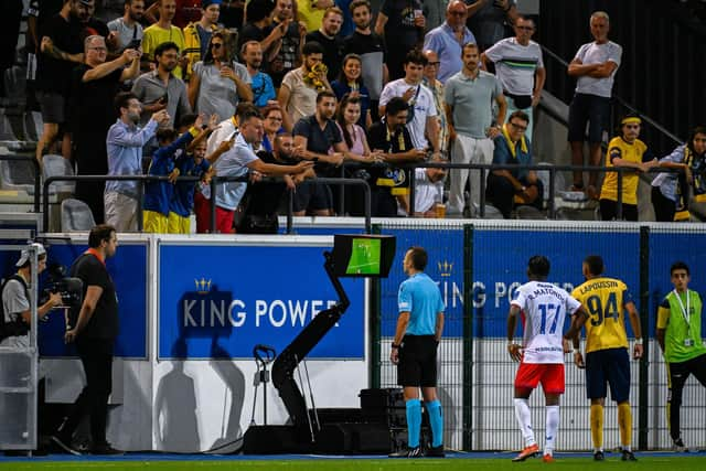 Referee Irfan Peljto looks at the VAR screen before awarding a penalty to USG.