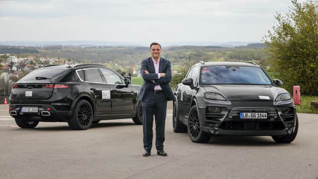 Michael Steiner, Porsche's head of research and development boss, with the prototype Macan EVs