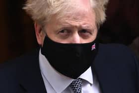 Prime Minister Boris Johnson leaves 10 Downing Street For PMQs yesterday. 