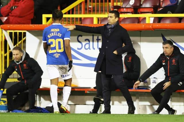 Rangers manager Giovanni van Bronckhorst gives striker Alfredo Morelos a pat on the back as he is substituted during the 1-1 draw against Aberdeen at Pittodrie. (Photo by Craig Williamson / SNS Group)