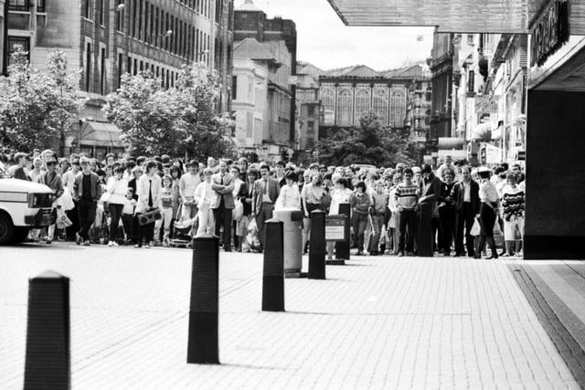Glasgow crowds and shoppers stand well back when a suspect package is discovered in a litter bin outside Marks & Spencer store in Argyle Street, July 1985. The bomb disposal squad were called in but the bomb scare proved to be a hoax.