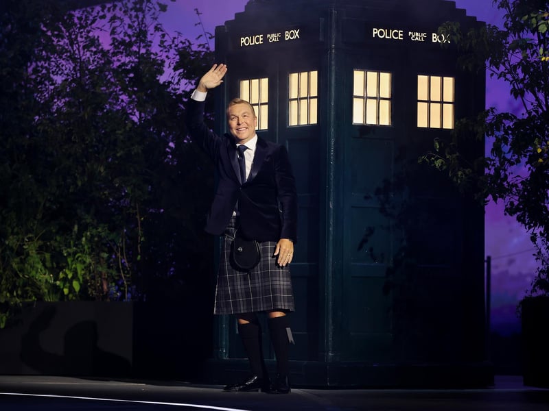 Sir Chris Hoy waves during the opening ceremony