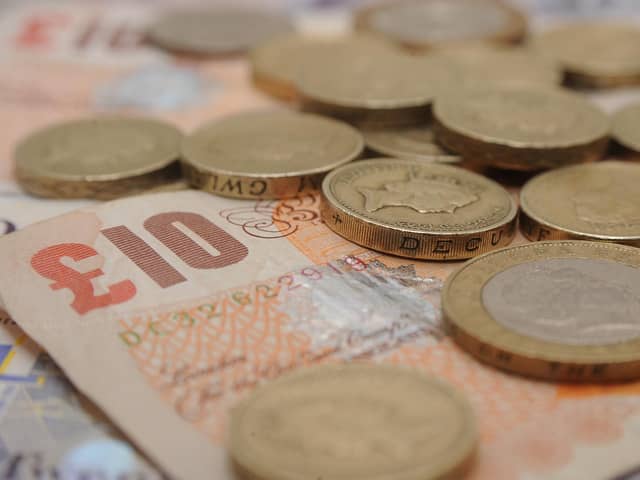 A selection of one pound coins, two pound coins and bank notes