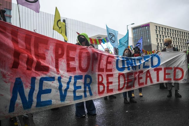 Extinction Rebellion protesters are seen outside the entrance to the COP26 site