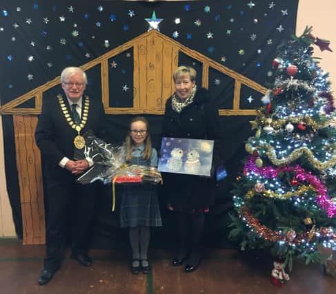 Eva, winner of the Provost's Christmas Card competition. With depute Provost Gary Pews, and Catherine Brown, widow of late Provost Alan Brown