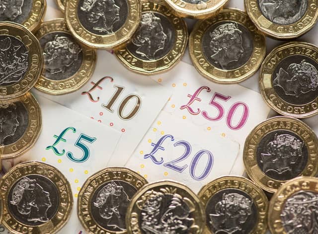 EMBARGOED TO 0001 FRIDAY OCTOBER 14 File photo dated 26/01/18 of a UK five pound, ten pound, twenty pound and fifty pound notes with one pound coins, as city bonuses have increased at more than twice the speed of wages since the 2008 financial crash, research suggests.