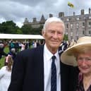 John and Josie Beeley at the Royal Garden Party, with the Royal Standard flying on the Palace of Holyroodhouse in the background.
