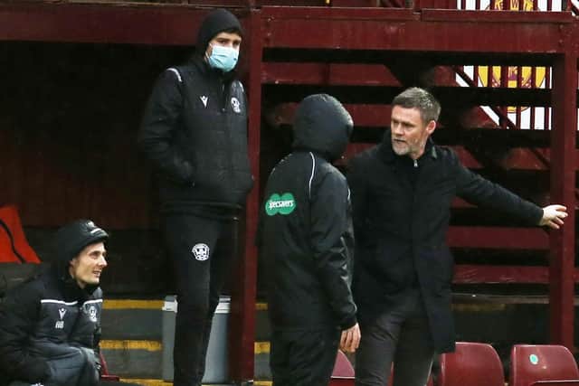 Motherwell manager Graham Alexander discusses the action with his backroom staff (Pics by Ian McFadyen)