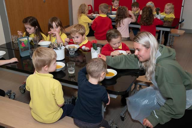 Children at Arthurlie Family Centre in Barrhead tuck into lunch along with child Development Officer Niamh Anderson.