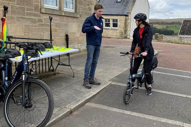 Volunteer Daniel Smith with Mairi McAllan as she tests out an e-bike!