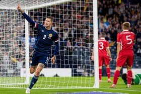 Lyndon Dykes celebrates making it 1-0. Picture: SNS