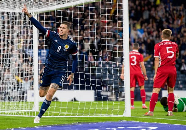 Lyndon Dykes celebrates making it 1-0. Picture: SNS