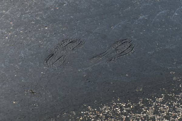 Footprints can be seen on a road near Empingham in Rutland, where tarmac has started to melt, as the UK encounters the hottest July day on record.
