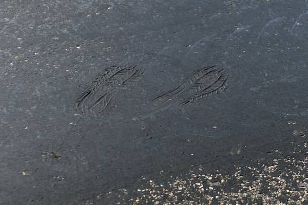 Footprints can be seen on a road near Empingham in Rutland, where tarmac has started to melt, as the UK encounters the hottest July day on record.