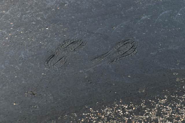 Footprints can be seen on a road near Empingham in Rutland, where tarmac has started to melt, as the UK encounters the hottest July day on record.