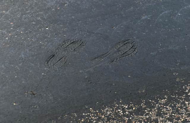 Footprints can be seen on a road near Empingham in Rutland, where tarmac has started to melt, as the UK encounters the hottest July day on record.