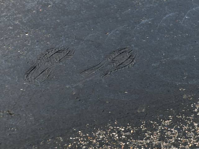 Footprints can be seen on a road near Empingham in Rutland, where tarmac has started to melt, as the UK encounters the hottest July day on record.