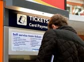 File photo dated 08/12/14 of a train passenger buying a ticket at Waterloo Station in central London, as several train companies are suffering problems accepting card payments for tickets.
