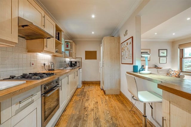 The kitchen has a breakfast bar and butcher block worktops.