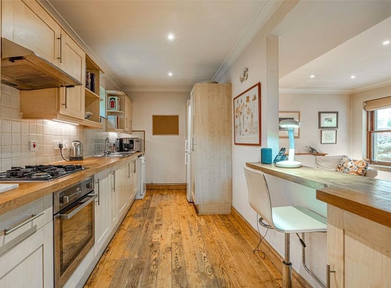 The kitchen has a breakfast bar and butcher block worktops.