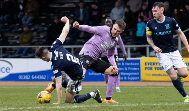 Rangers midfielder Aaron Ramsey challenges Dundee defender Cammy Kerr during the Scottish Cup quarter-final at Dens Park. (Photo by Alan Harvey / SNS Group)