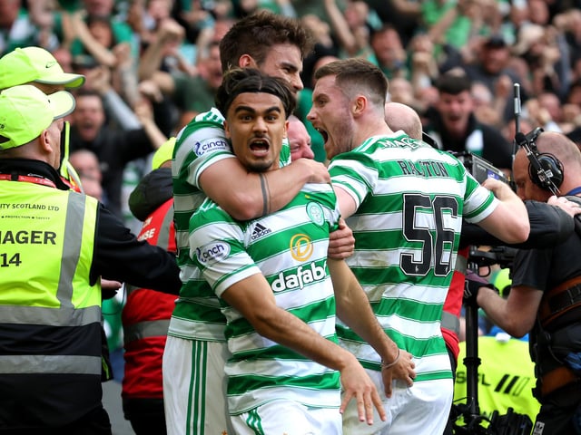 Jota celebrates with Matt O'Riley and Anthony Ralston.