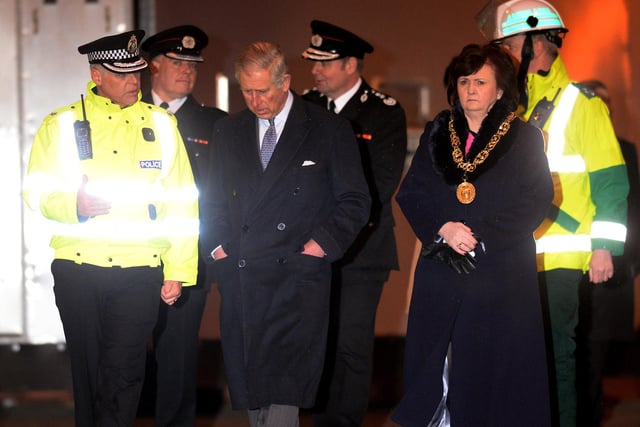 Prince Charles meets with emergency services workers and survivors at the Clutha Bar helicopter crash site.
