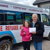 Niamh Burke surprises John Penman at Cloybank with a cheque for £1,000