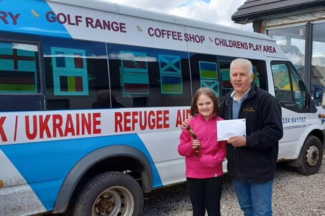Niamh Burke surprises John Penman at Cloybank with a cheque for £1,000