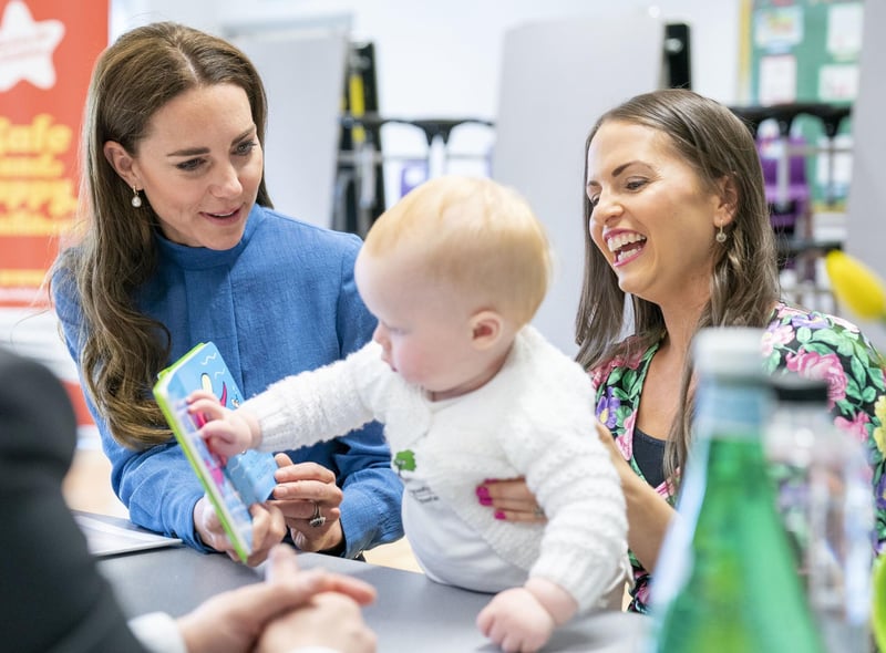 Kate meets Laura Molloy and her 10-month-old son Saul Molloy during a visit to St. John's Primary School.