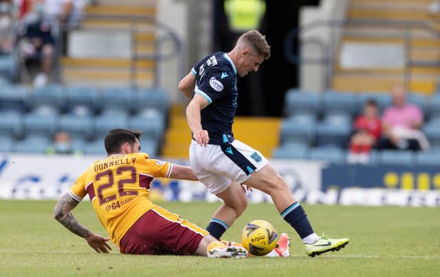 'Well defender Liam Donnelly slides into a tackle