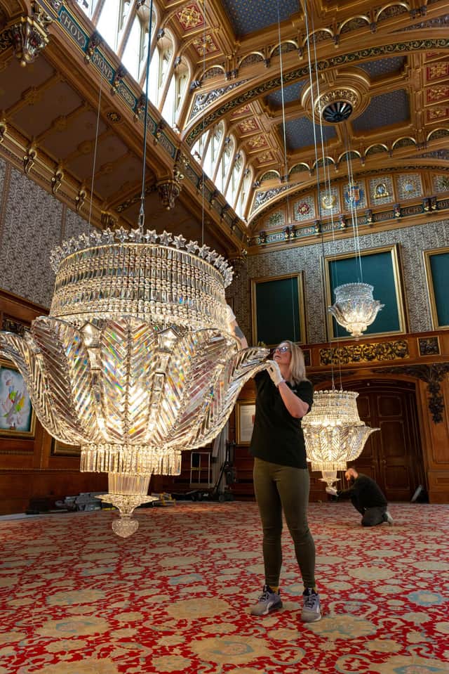 Chandeliers in the Waterloo Chamber at Windsor Castle are given a final check and polish in preparation for the room's reopening to visitors on Saturday April 9 following renovation works.