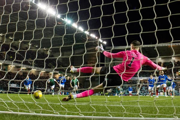 Hibs goalkeeper Matt Macey is beaten by Kemar Roofe's penalty for the only goal of the game