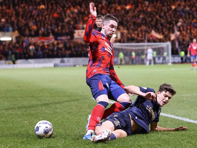 Rangers' Scott Wright and Dundee's Owen Beck battle for the ball during the cinch Premiership match on Wednesday