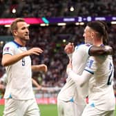 Bukayo Saka celebrates with Harry Kane and Phil Foden after scoring England's third goal against Senegal (Photo by Catherine Ivill/Getty Images)