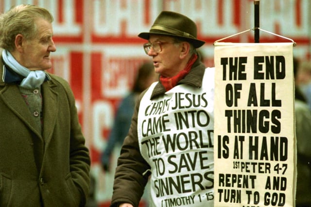 A street evangelist tries to persuade a passer-by that 'The End of All Things is At Hand' in Argyle Street during the Boxing Day sales - December 1992.