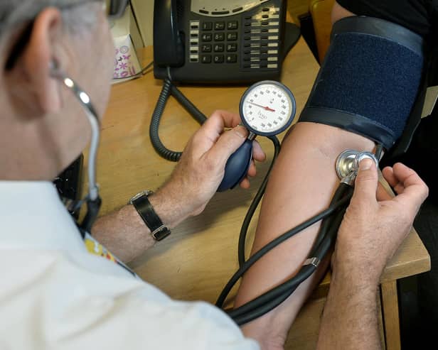 Dr Laurence Buckman checks a patient's blood pressure in his practice room at the Temple Fortune Health Centre GP Practice near Golders Green, London.