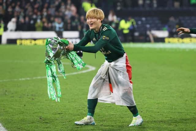 Celtic’s Kyogo Furuhashi celebrates with the Premier Sports Cup Trophy after scoring a double. (Photo by Craig Williamson / SNS Group)