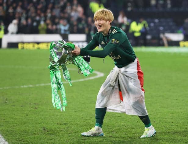 Celtic’s Kyogo Furuhashi celebrates with the Premier Sports Cup Trophy after scoring a double. (Photo by Craig Williamson / SNS Group)