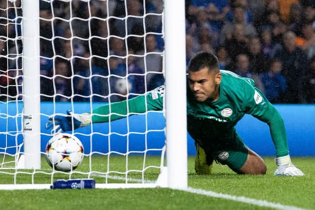 PSV goalkeeper Walter Benitez lets the ball slip over the line from Tom Lawrence's free kick to make it 2-1 to Rangers.